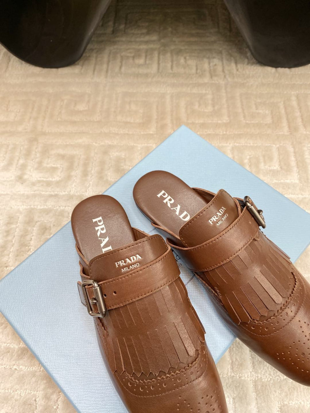 PRADA TASSEL MULES IN RUSSET BROWN LAMBSKIN